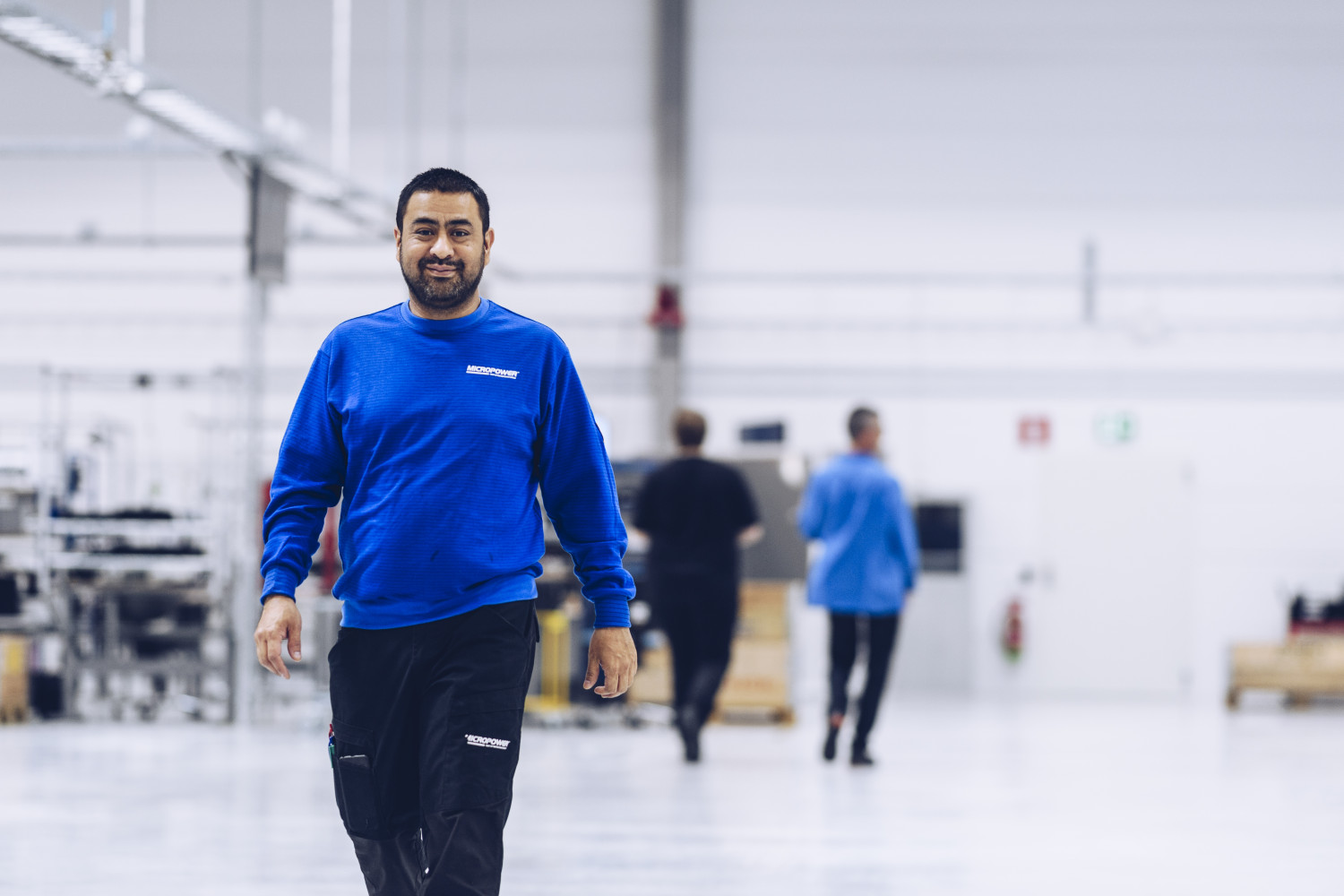Happy employee in micropower's battery factory