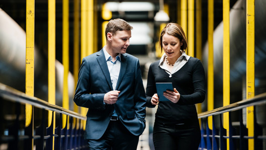 Two employees at micropower discuss in the factory