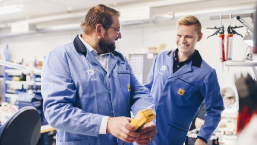 Two employees at micropower discuss in the factory at Micropower